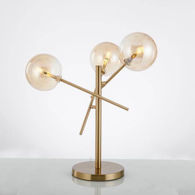 Design table lamp in gold with glass balls