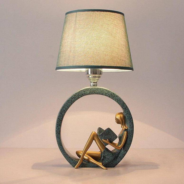 LED table lamp with sculpture-like body and lampshade fabric