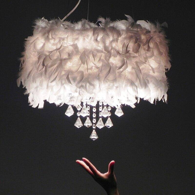 Round modern LED chandelier with feathers and crystal glass