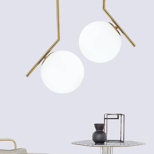 pendant light design with gold bar and glass ball
