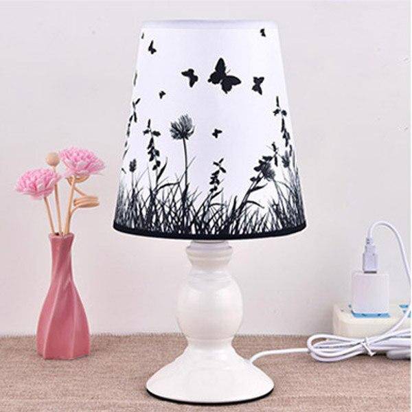 White bedside lamp with lampshade fabric with butterfly and flowers