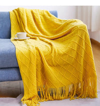 plaid tricot doux avec pompons style cosy salon