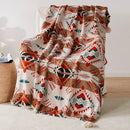 Plaid tricoté style bohème motifs géométriques avec pompons