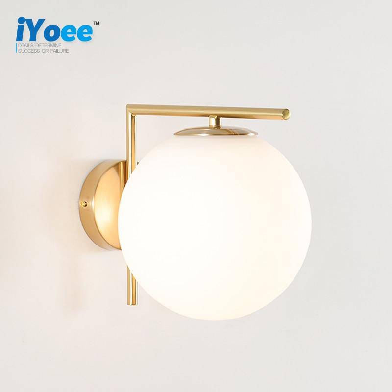 wall lamp design with golden branch and glass ball