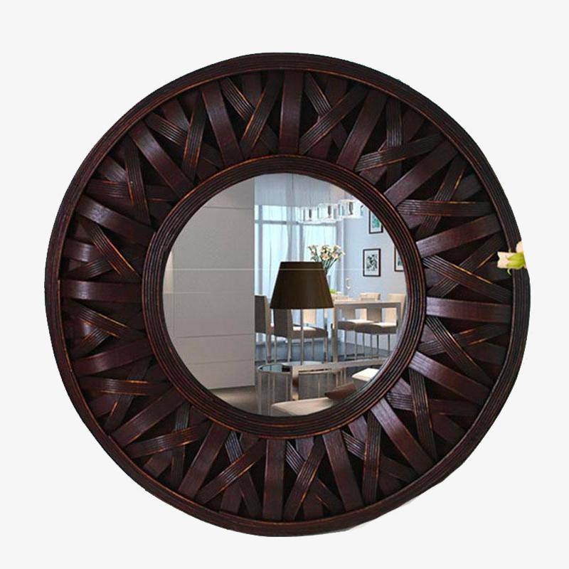 Round decorative wall mirror in woven dark wood