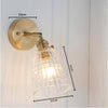 Applique murale dorée à LED et abat-jour en verre