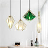 Suspension design à LED en verre et cage dorées
