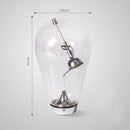 Lampe à poser design à LED chromé dans ampoule en verre