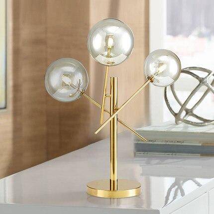 Lampe à poser design dorée et boules en verre
