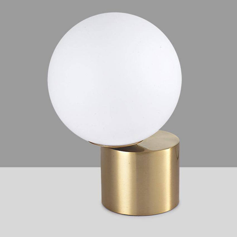 Bedside lamp with gold base and modern glass ball