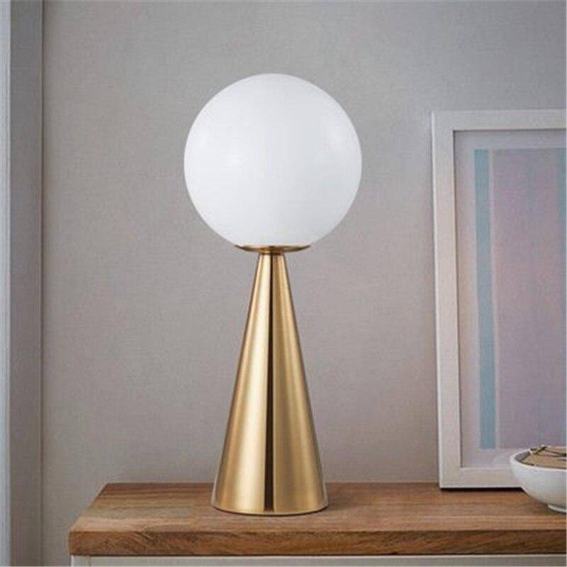 Design bedside lamp with golden cone and ball lamp