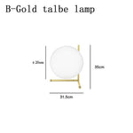 Lampe de chevet design dorée avec boule en verre Lampen