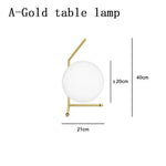 Lampe de chevet design dorée avec boule en verre Lampen