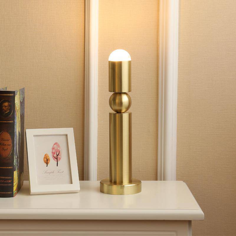 Modern LED table lamp in gold-coloured elongated cylinder