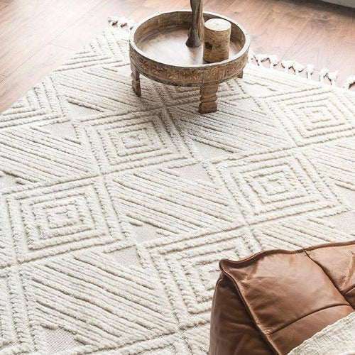 Rectangular white Berber carpet with raised check pattern and fringes