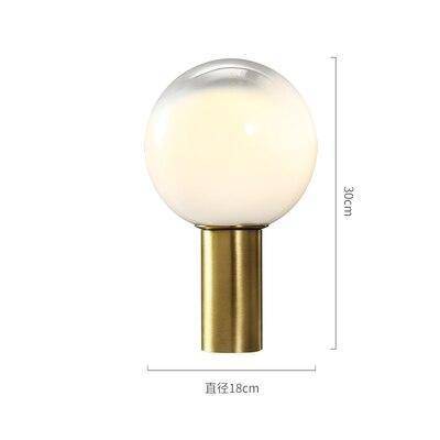 Lampe à poser design LED de forme cylindrique dorée et boule en verre blanc