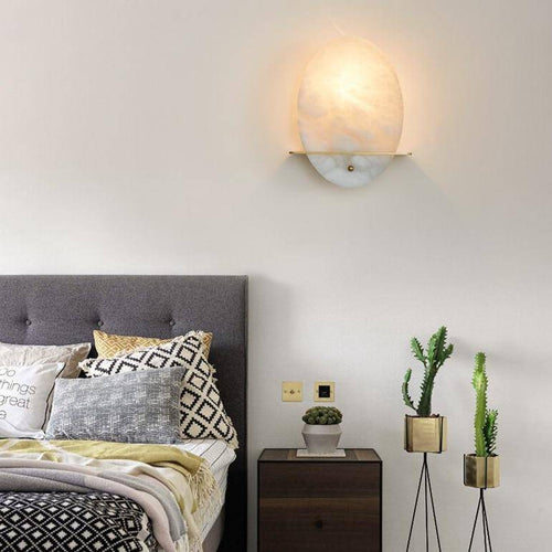 Lámpara de pared design LED de forma ovalada en mármol blanco y base dorada