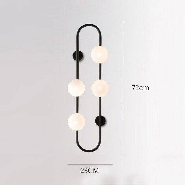 Lámpara de pared design LED con anillo metálico y bola de cristal