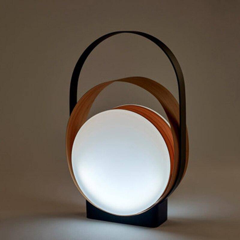 LED design table lamp with metal rings and light disc