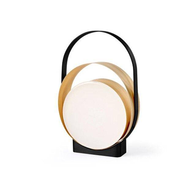 LED design table lamp with metal rings and light disc