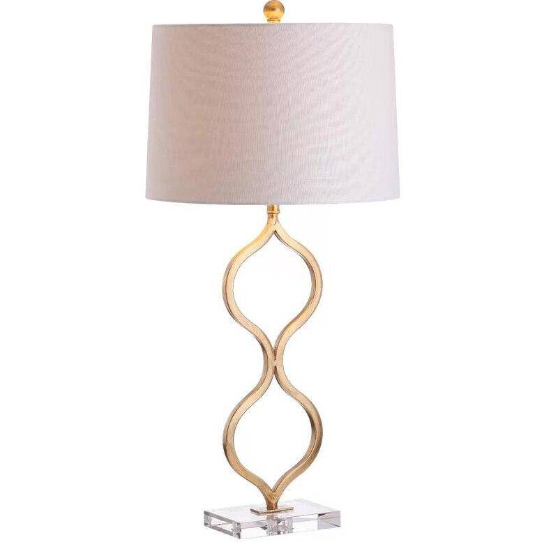 LED design table lamp with curved gold stem and lampshade