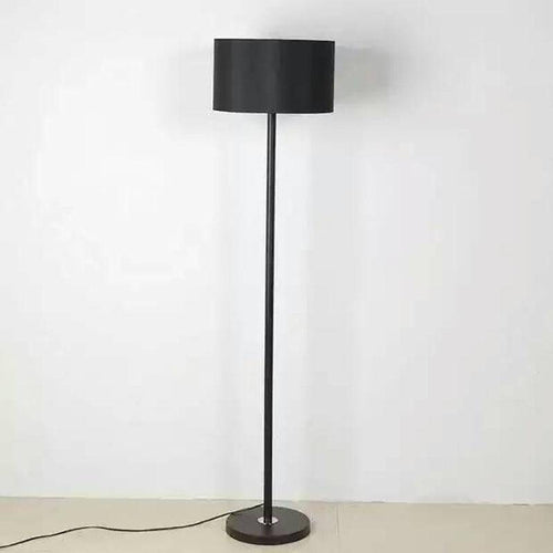 Floor lamp on black stand with lampshade