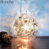 Lampe à poser boule en verre avec feuilles