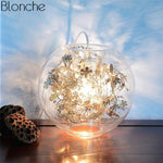 Lampe à poser boule en verre avec feuilles