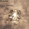 Lampe à poser boule en verre avec feuilles