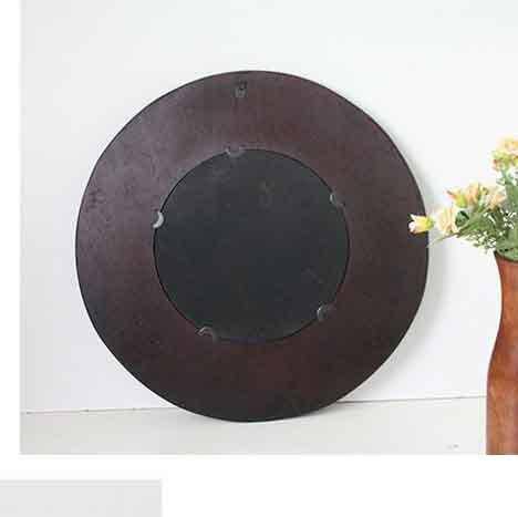 Round decorative wall mirror in woven dark wood