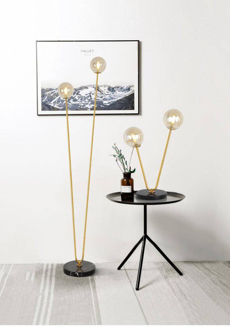 Design bedside lamp with two golden branches and glass balls