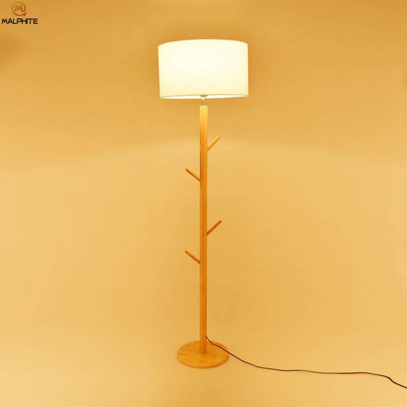 Floor lamp with lampshade fabric and wooden foot with branches