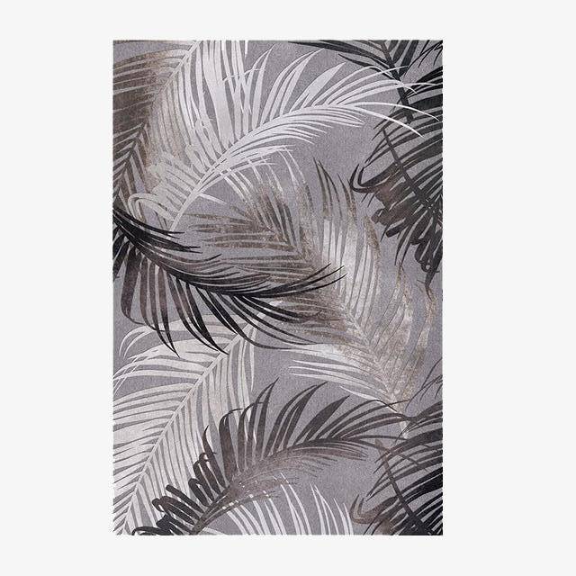 Alfombra rectangular con motivos de hojas de palmera en blanco y negro